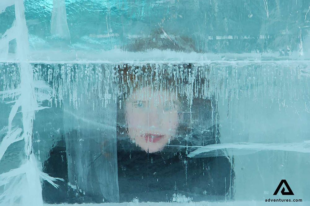 child looking through ice wall