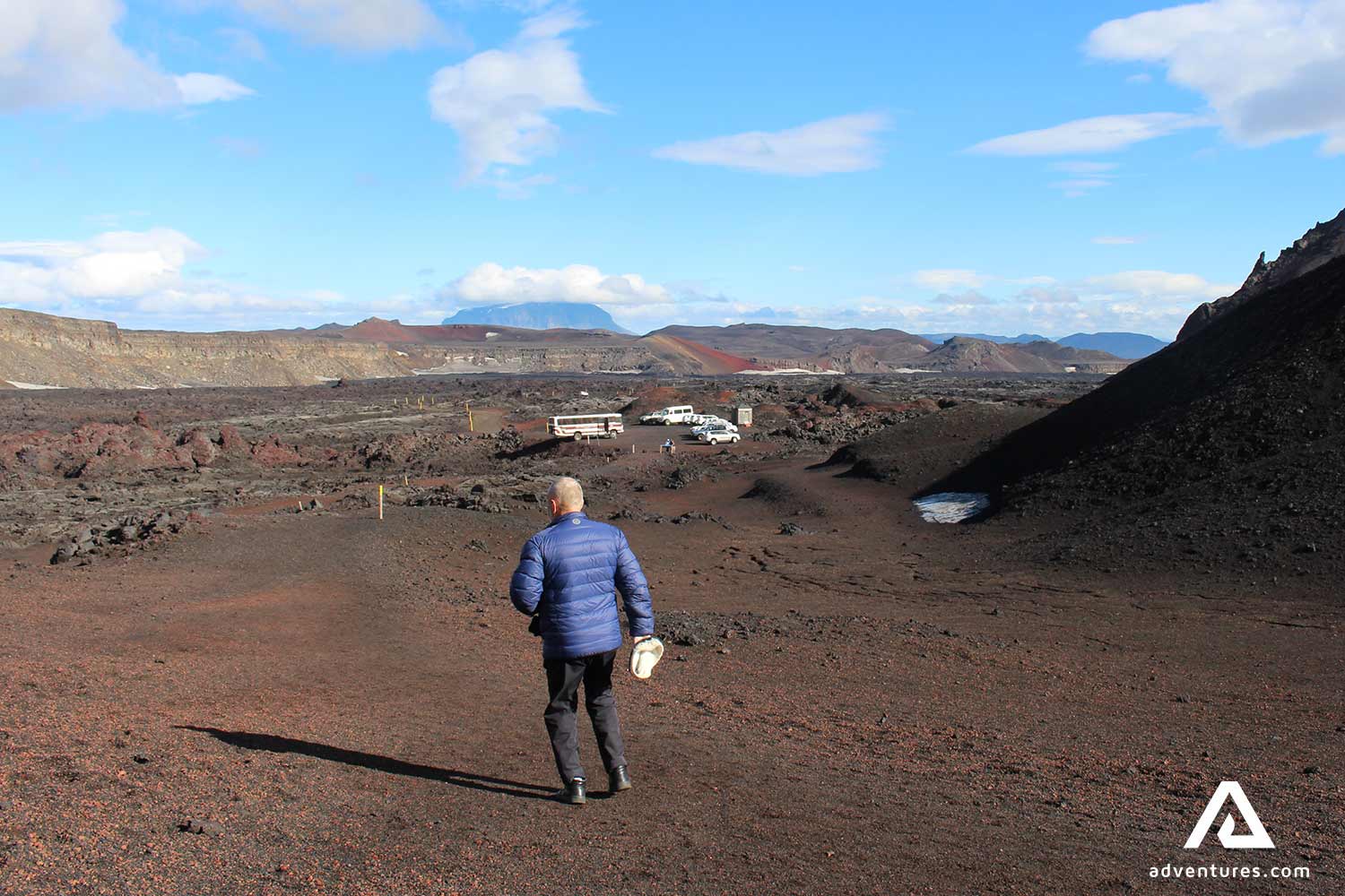man walking on askja crater in iceland