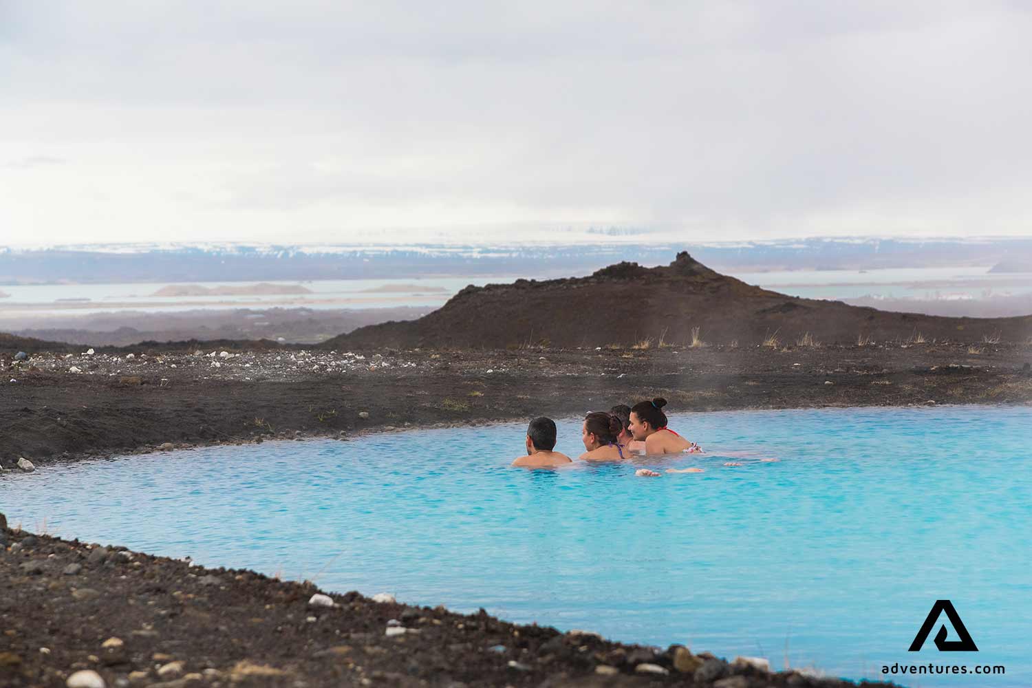 friends relaxing in hot springs in iceland