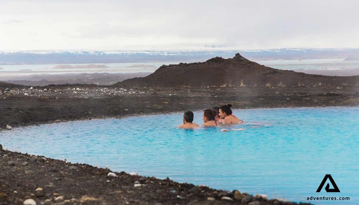 friends relaxing in hot springs in iceland