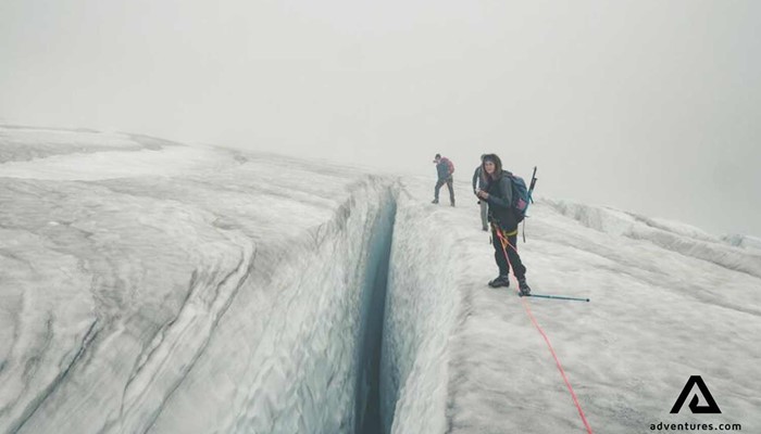 people mountaineering near glacier crevasse in iceland