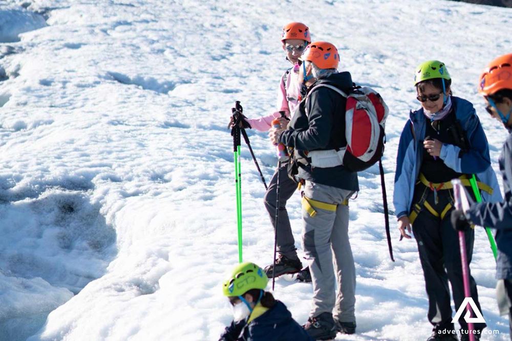 group of people hiking on glacier