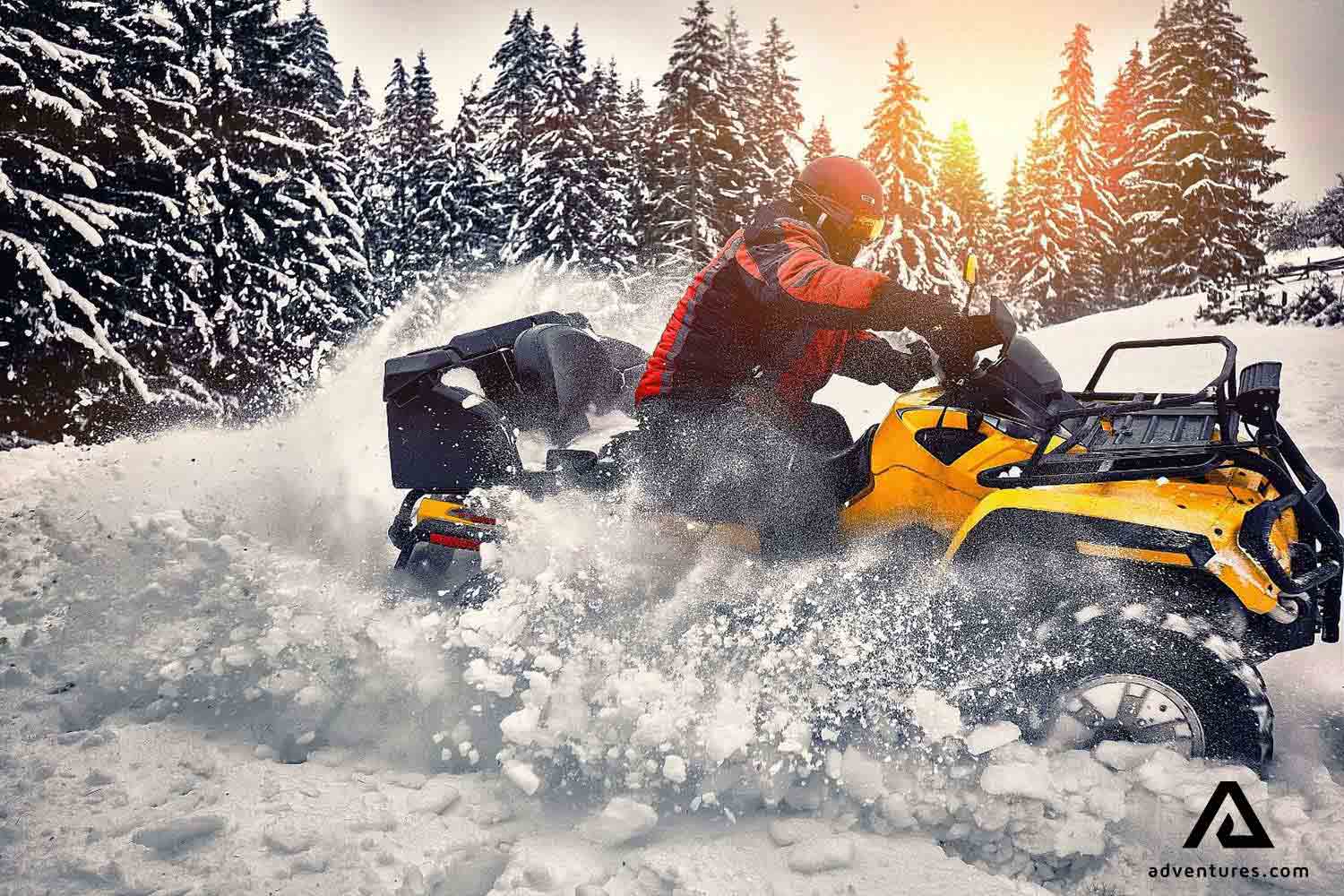 driving atv bike on winter in finland