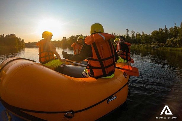 group swimming in inflatable raft at finland