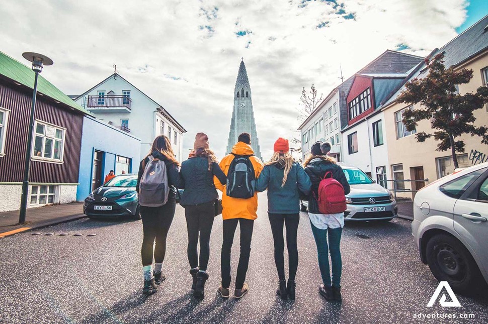 group of friends walking near hallgrimskirkja in reykjavik