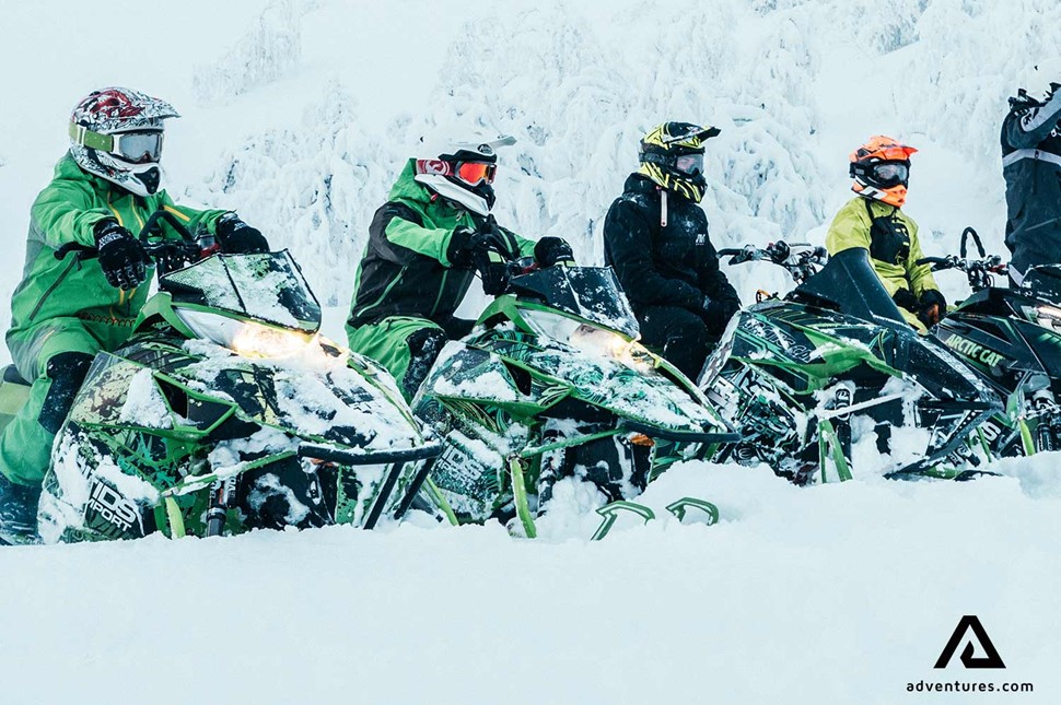 small group snowmobiling in Sweden during winter