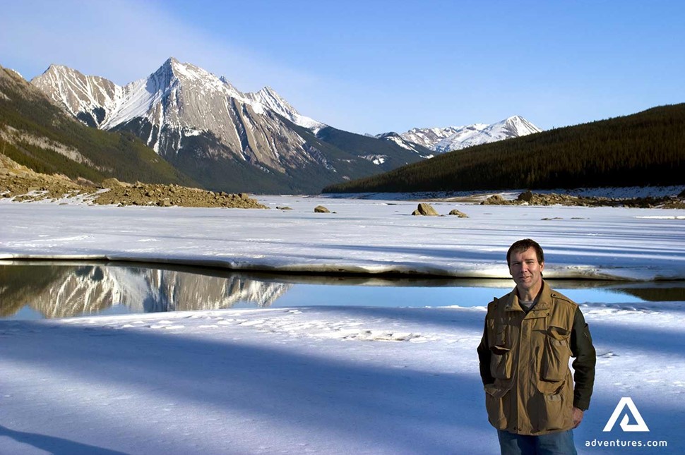 man standing by frozen Medicine Lake