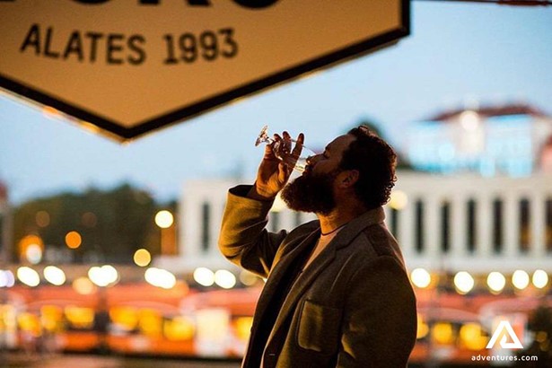 man drinking beer in rooftop bar Tallinn