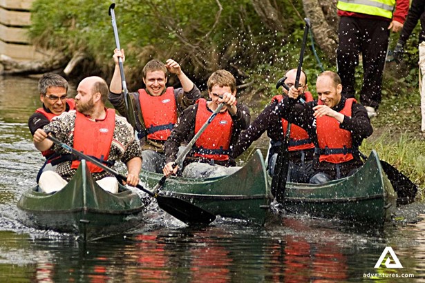 happy men canoeing in Norwegian river