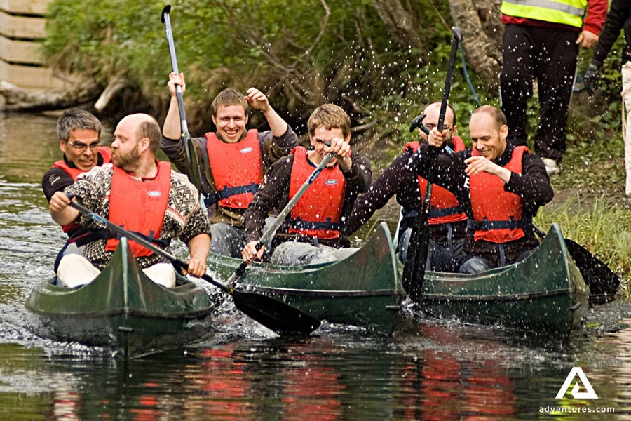 men canoeing in river