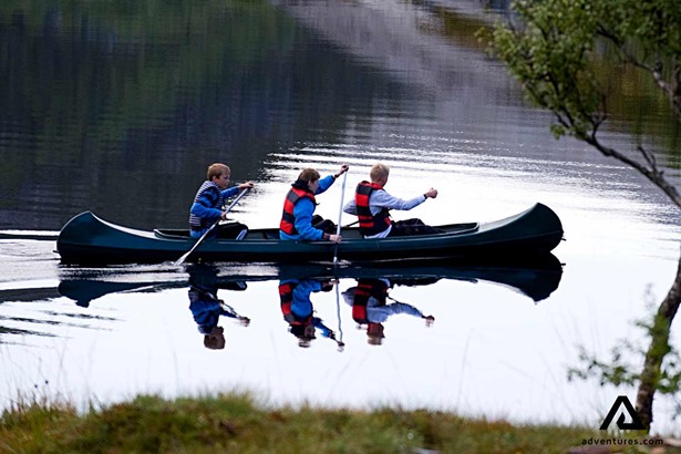 three children canoeing in Norway