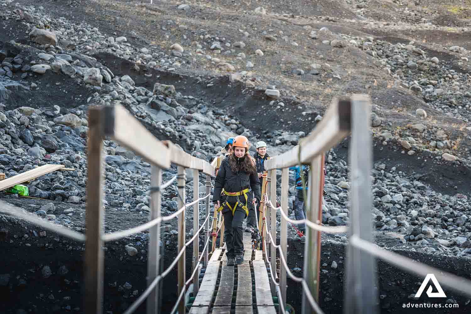 explorers walking on bridge