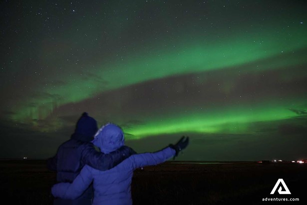 couple watching Northern lights in Iceland