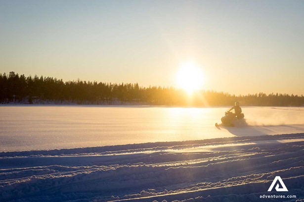 snowmobiling over frozen lake in Sweden