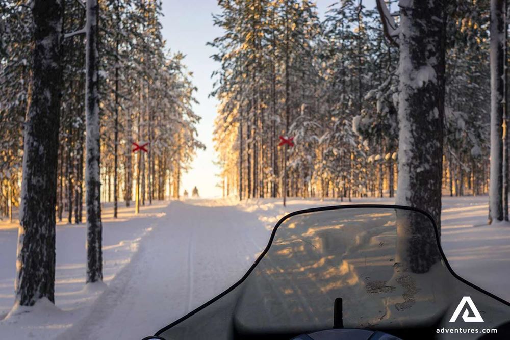 snowmobiling in winter forest