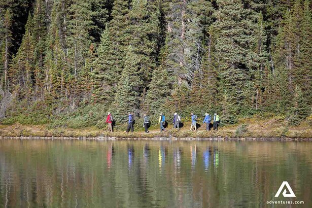 explorers trekking by the lake in Canada