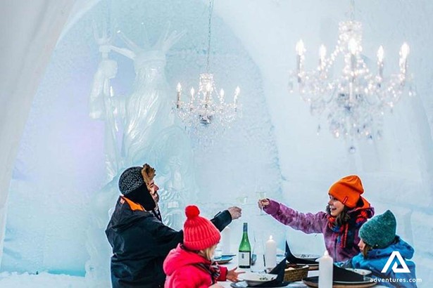 family eating dinner in arctic ice hotel