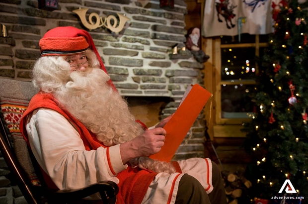 Santa Claus reading book in festive hut
