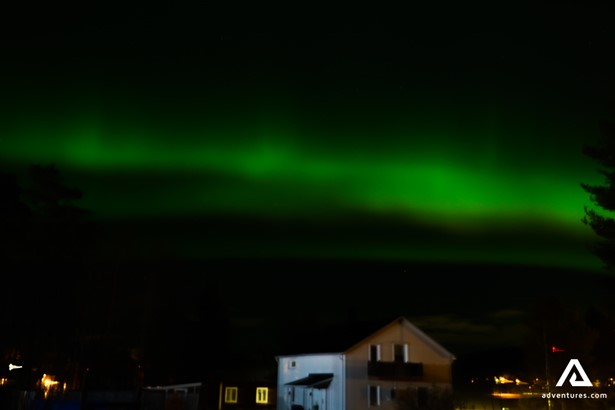 Northern lights above houses in Lapland