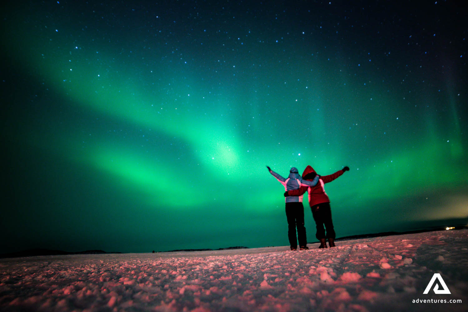 happy friends watching Aurora Borealis