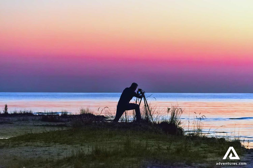 Photographer taking pictures of Singing Sands in Canada