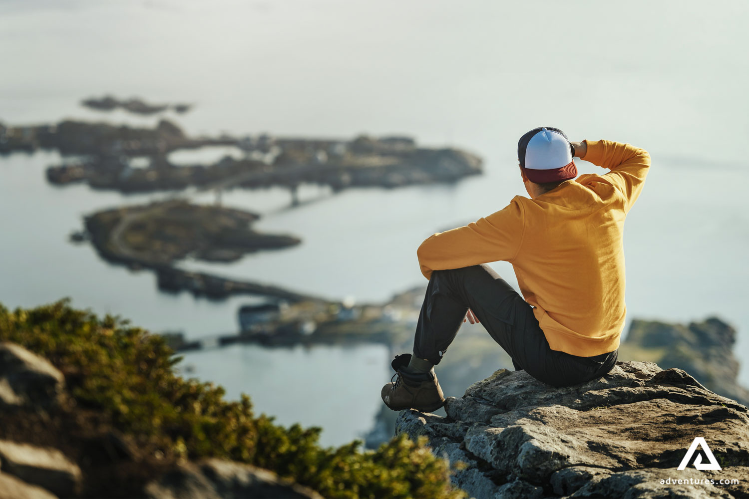 Man Sitting in The Summit of the Mountain in Lofoten in Norway
