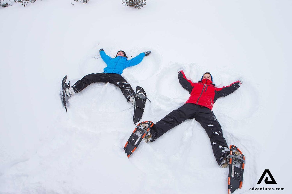 Happy children making a snow angel in Canada