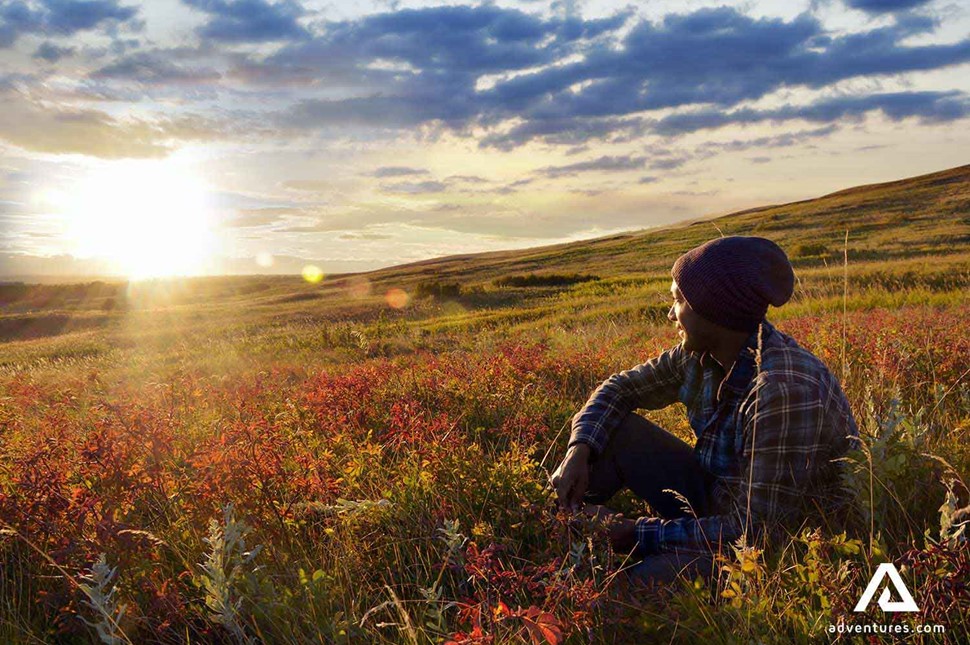 Man in the fields watching sunset in Canada