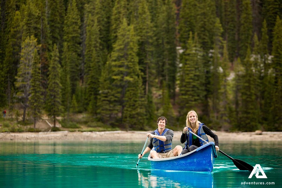Happy couple canoeing in Canada