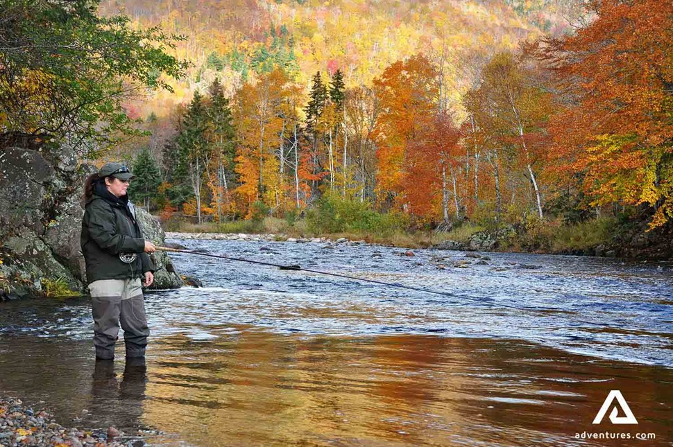 Woman fishing in the river of Cape Breton National Park