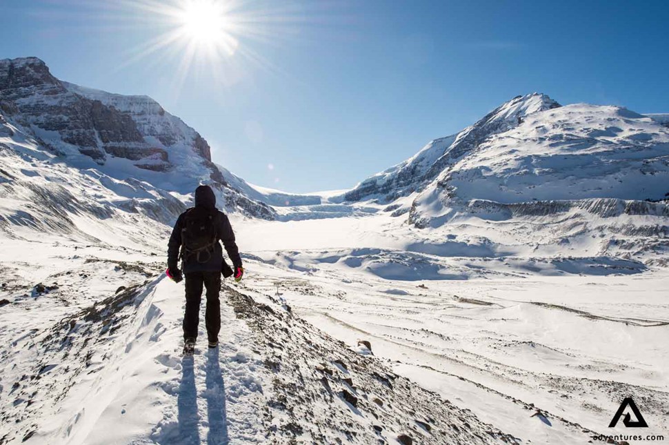 Young man hiking at Athabasca Glacier in Canada