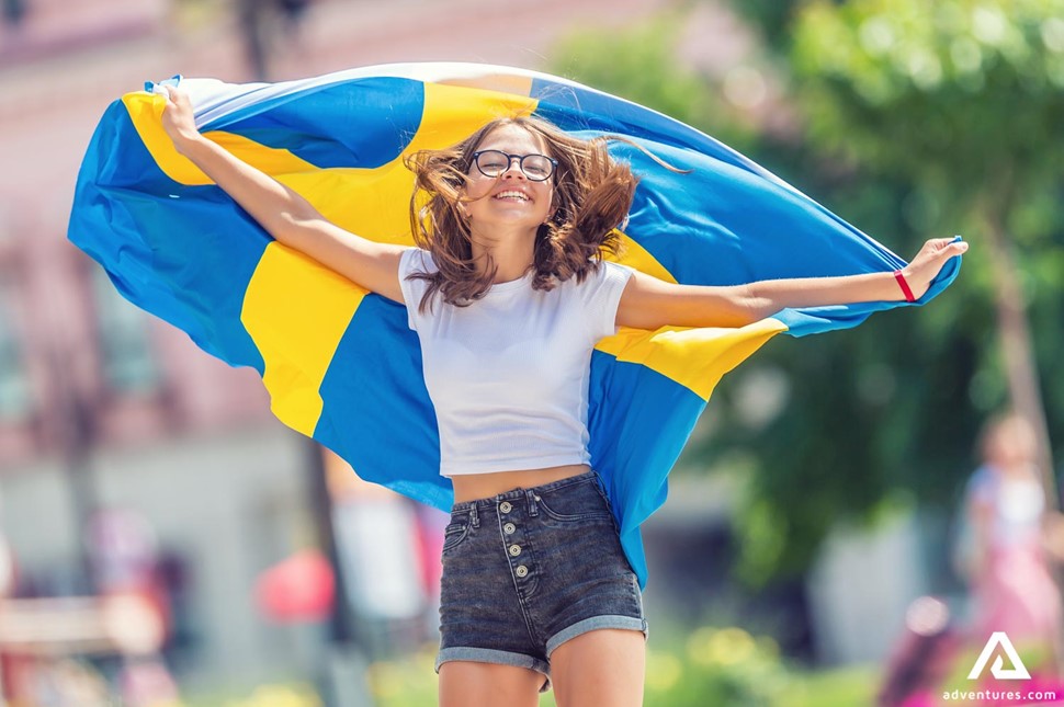 happy woman with a sweden flag 