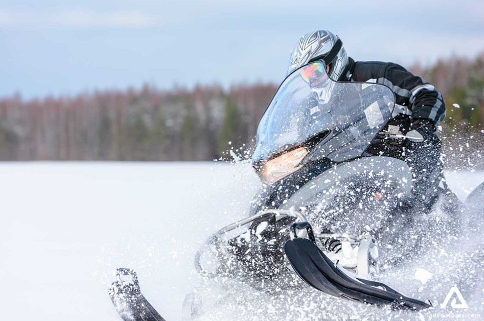 Man Snowmobiling during winter in Canada