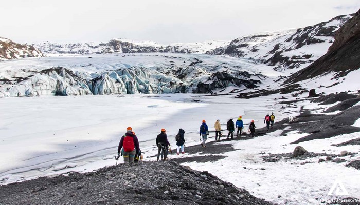 Group walking towards glacier in Iceland