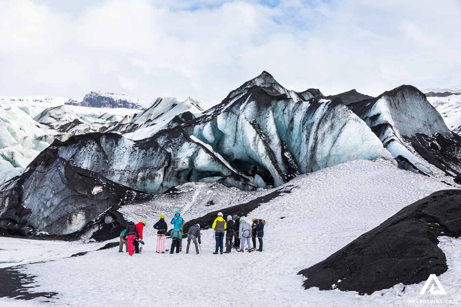 Group standing by glacier crevasses