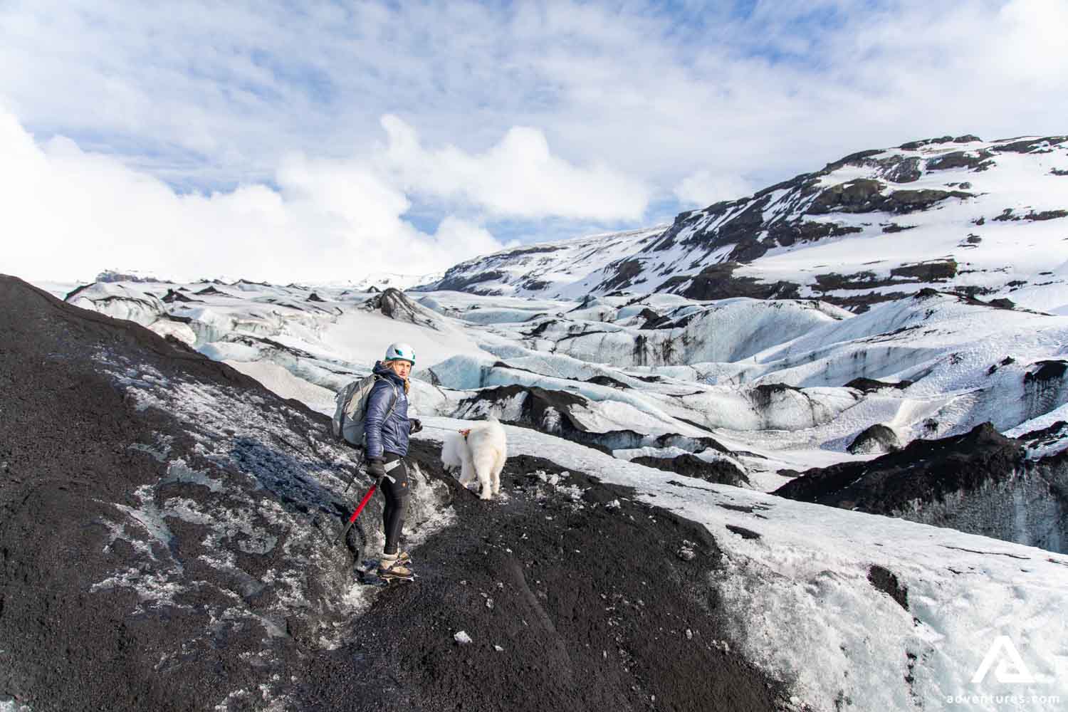 Woman and dog on a glacier