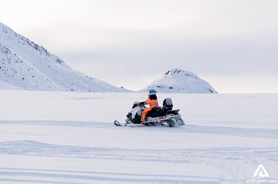 Man Snowmobiling on Langjokull Glacier
