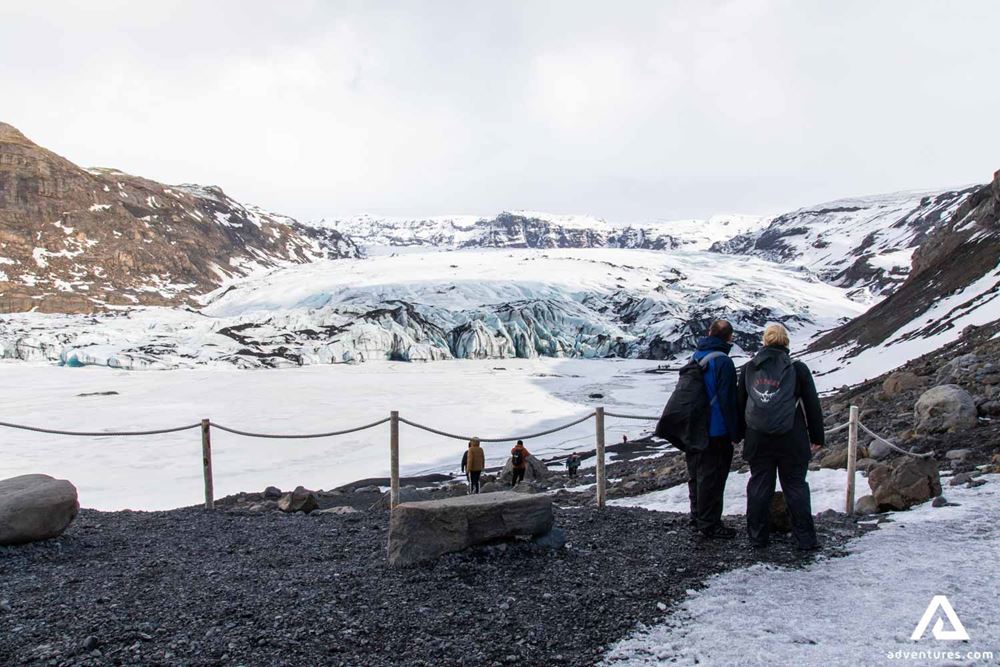Couple Looking at Solheimajokull Glacier