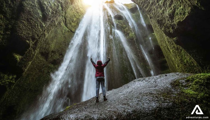 Happy Woman by Gljufrabui Waterfall in Iceland