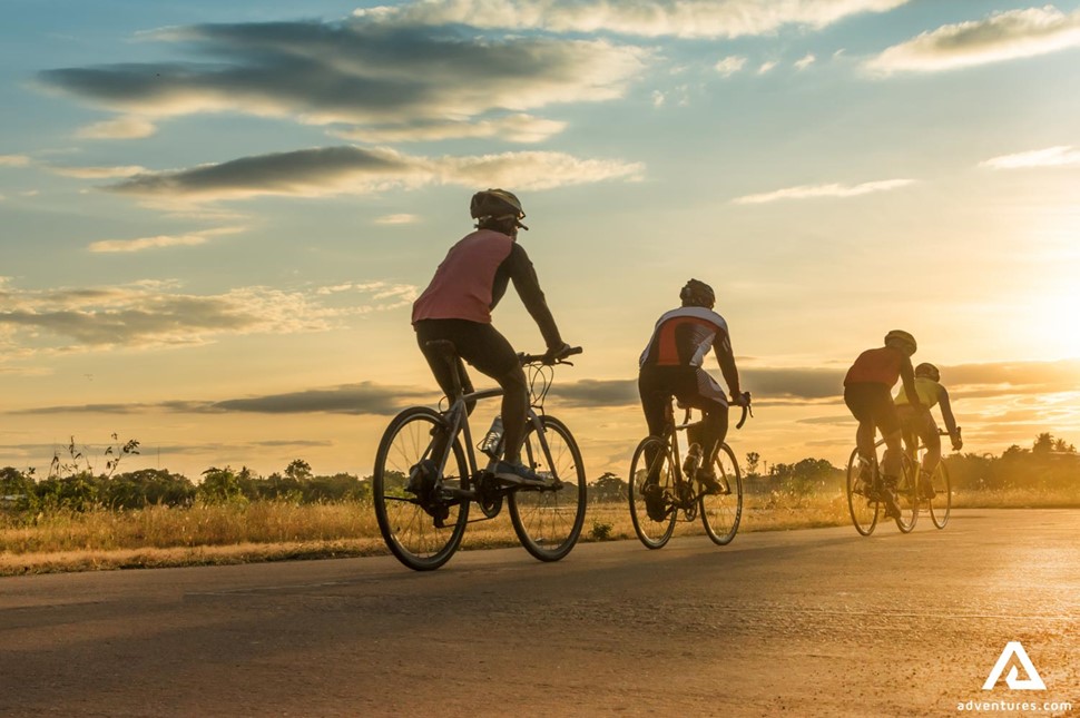 Group of Men Cycling at Sunset in Canada