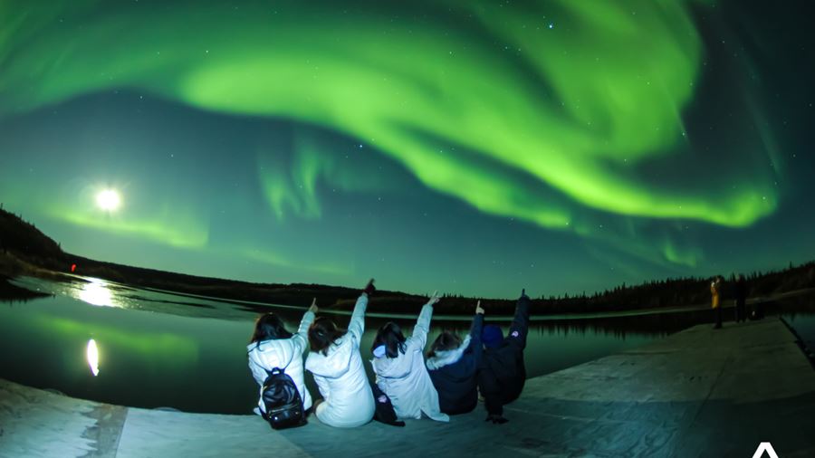 Group Posing with Northern Lights