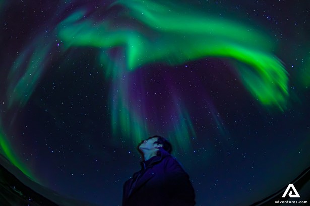 Man Standing Under Northern Lights in Canada