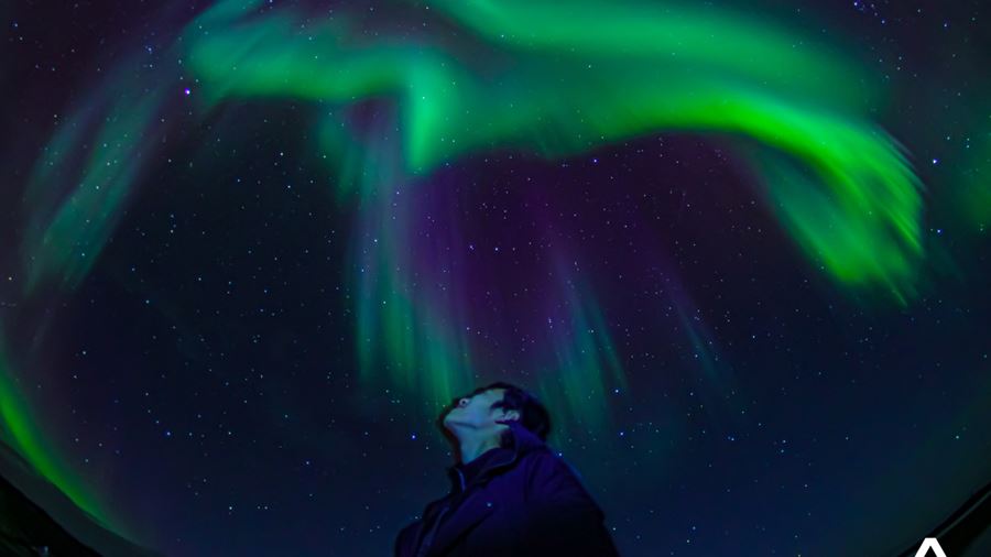 Man Standing Under Northern Lights