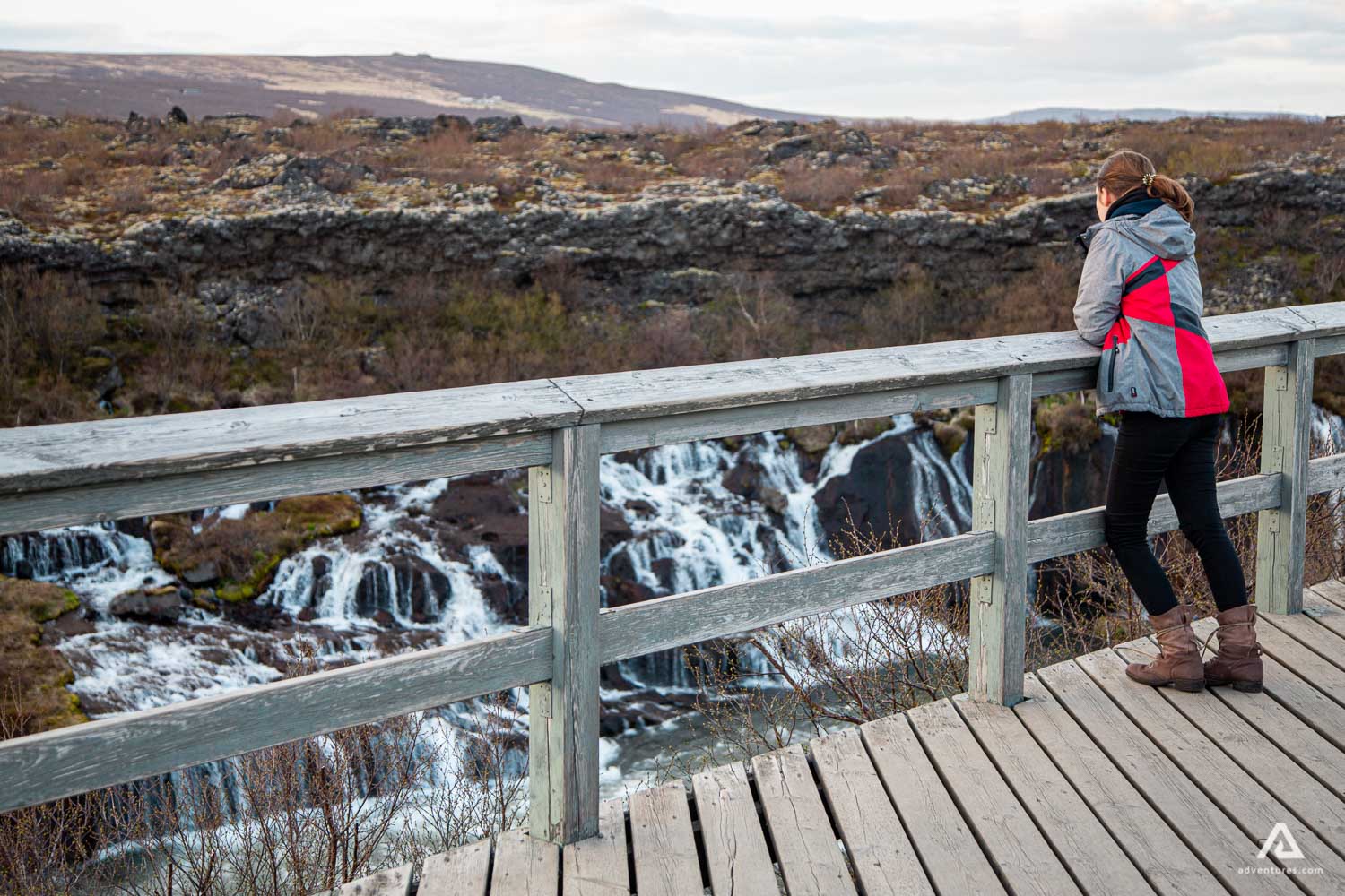 Woman Looking at Barnafoss Waterfall from Viewpoint