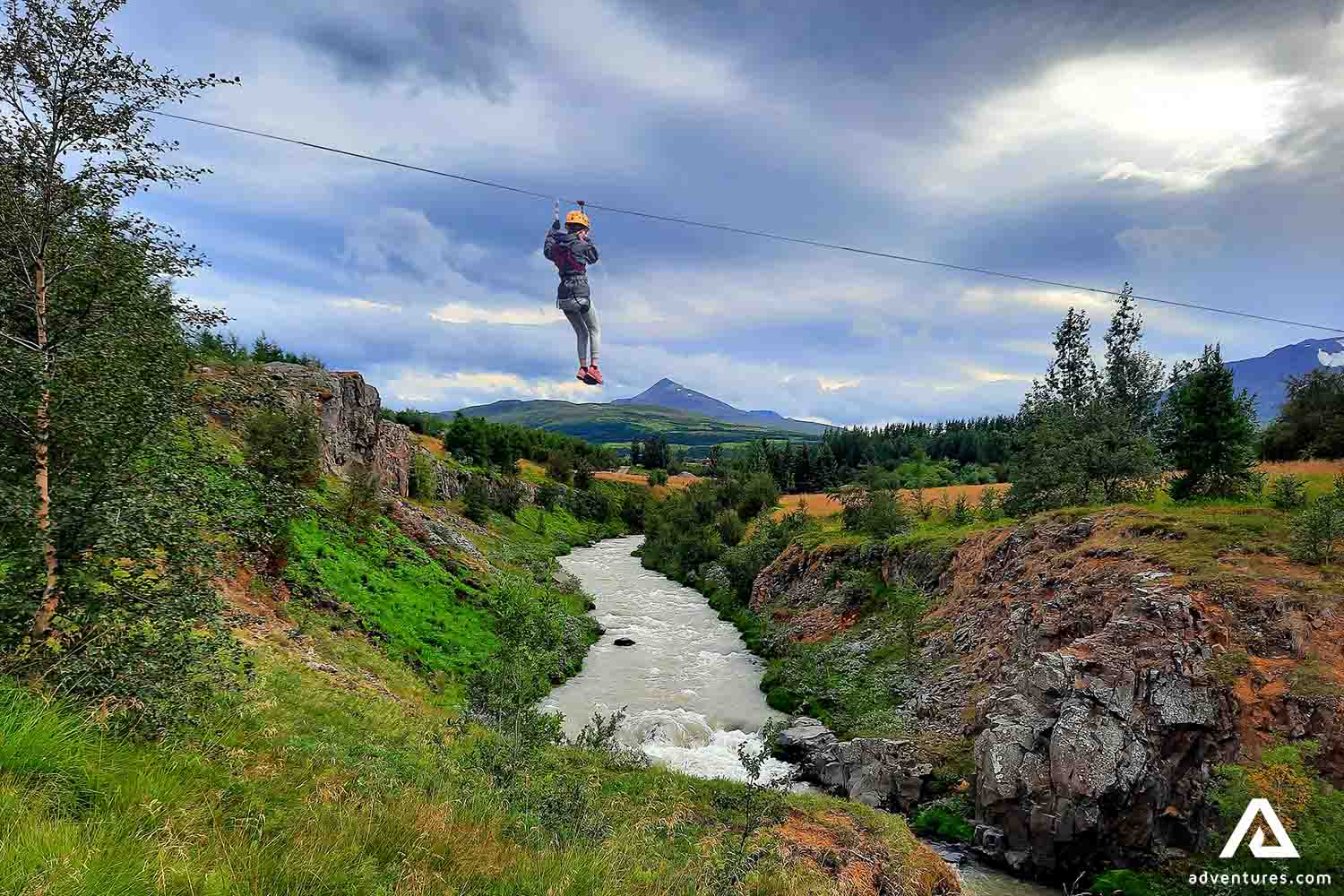 Woman Ziplining over River in Iceland