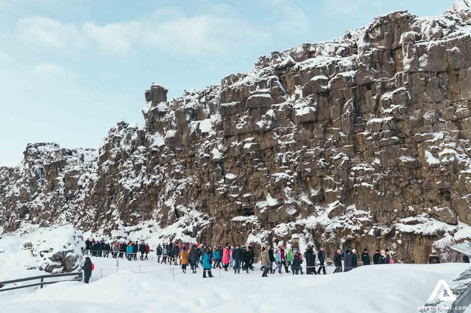 People Walking by Tectonic Plates in Iceland