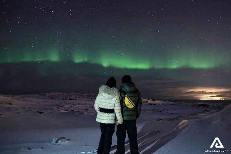 Couple Enjoying View of Aurora in Iceland