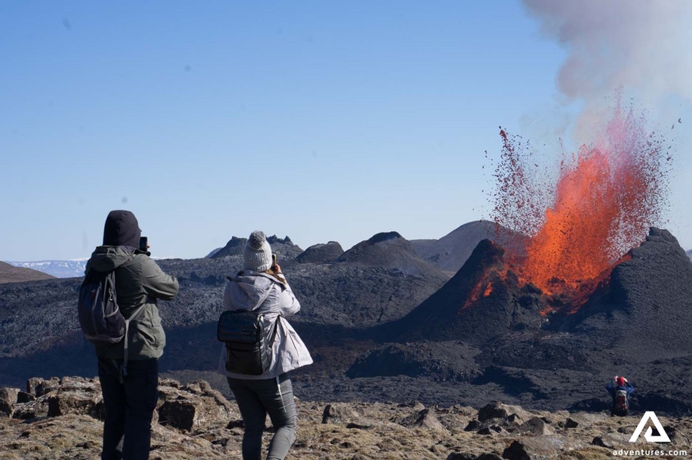 Couple Taking Pictures of Erupting Volcano