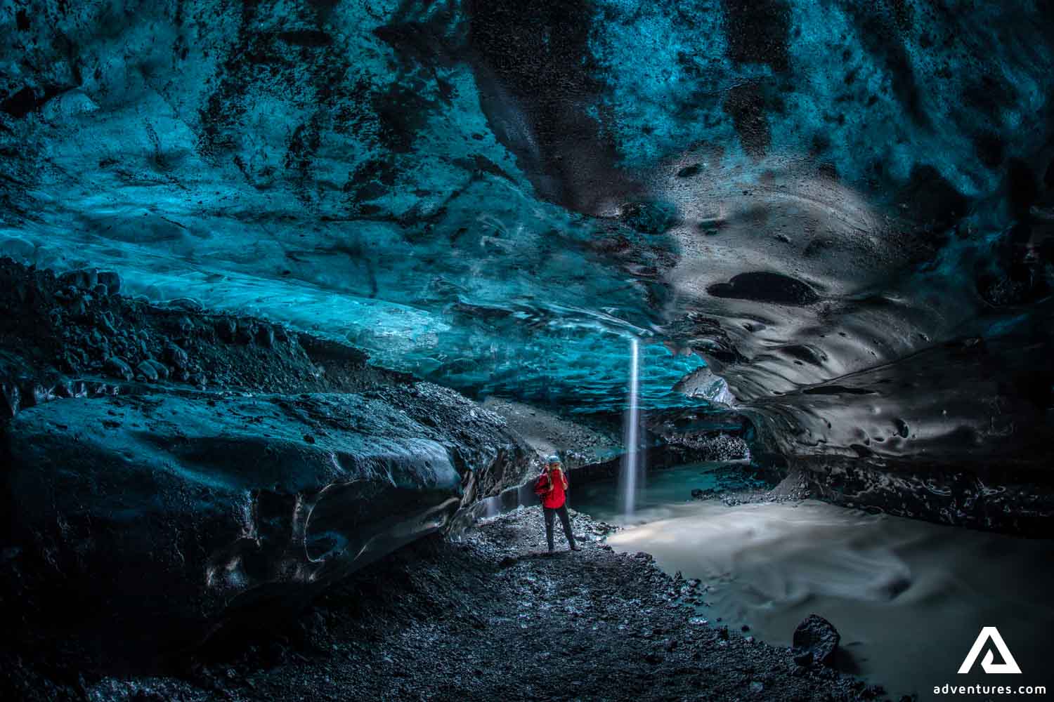 Woman with Red Jacket in Ice Cave