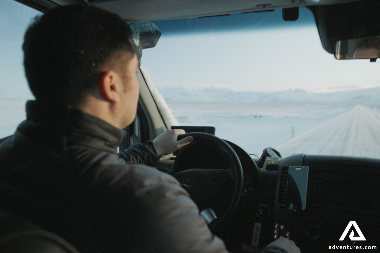 Man Driving on Snowy Roads in Iceland